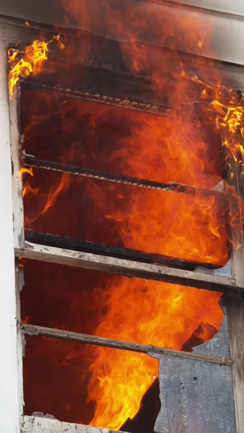 An intense fire has engulfed the building, causing chaos and panic among the Stock Footage 305278745