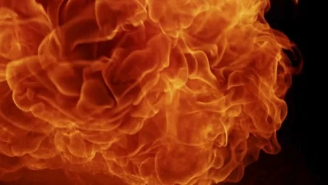 Intense fireball explosion bursting against a dark black background Stock Footage 329676370