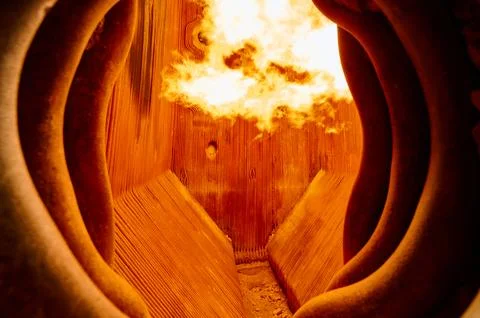 Intense flame combustion inside a steam boiler furnace at a thermal power plant Stock Photos