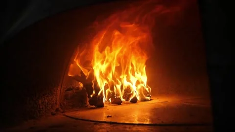 Intense Flames Burning Inside a Traditional Italian Wood-Fired Pizza Oven Stock Footage 337677732