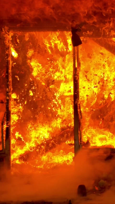 Intense Flames Erupting Aggressively from a Building, Creating Chaos and Stock Footage 305279776