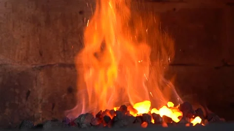 Intense Flames Erupting from a Forge, Radiating Heat and Light as Hot Coals Video stock 341316551