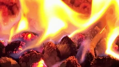 Intense flames flicker and dance across darkened fuel in mesmerizing disp. video Video stock 310733897