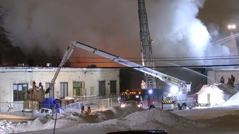 Intense flames thick smoke cloud firefighters extinguish fire using water gun Stock Footage 308728852