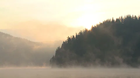 Intense fog sunrise over mountain lake Video stock 31463243