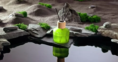 Intense fragrance diffuser on a lunar landscape with small pond. Stock Footage 336021051