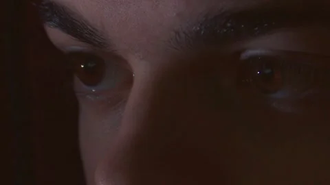 Intense Gaze of a Young Developer Working at Night, Blue Tones and Screen Glow. Stock Footage 326352616