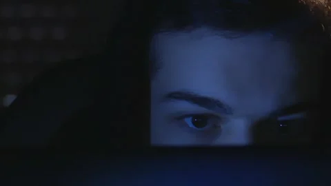Intense Gaze of a Young Developer Working at Night, Blue Tones and Screen Glow. Stock Footage 326352639