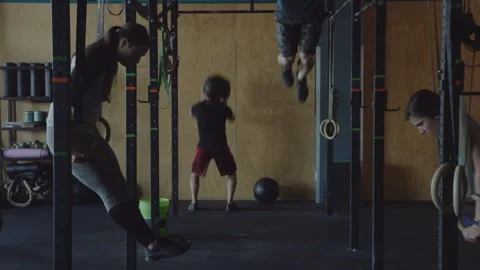 Intense group circuit training session in dimly lit gym atmosphere Stock Footage 312707284