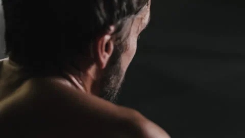 Intense gym workout where man wipes sweat while breathing heavily Stock Footage 312759910
