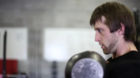 Intense Kettlebell Clean (Side Portrait) Stock Footage 22994699