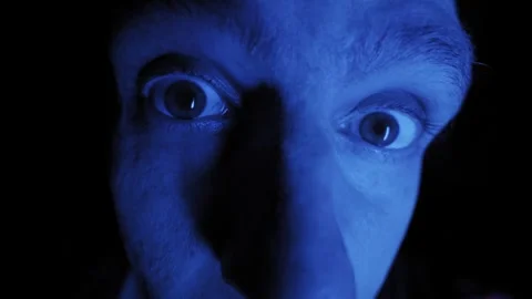 Intense Man Face Staring Wide Eyes Under Blue Light In Dark Stock Footage 326313234