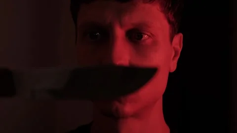 Intense man staring at a knife blade in extreme close up, suggesting dangerous Stock-Footage 347299743