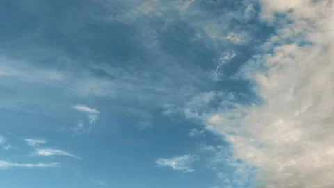 Intense movement of white and gray clouds across the blue sky, timelapse Stock Footage 108570762