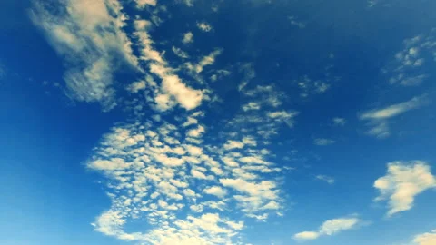 Intense movement of white and gray clouds across the blue sky, timelapse Stock Footage 109244008