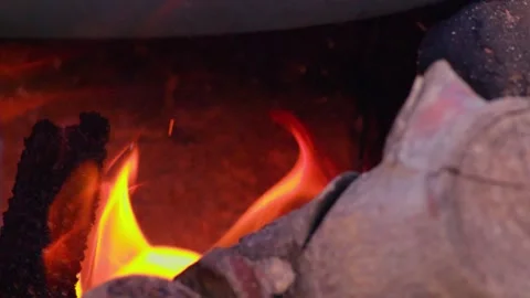Intense Orange and Yellow Flames Burning Among Charcoal Embers Vídeos de archivo 334709133