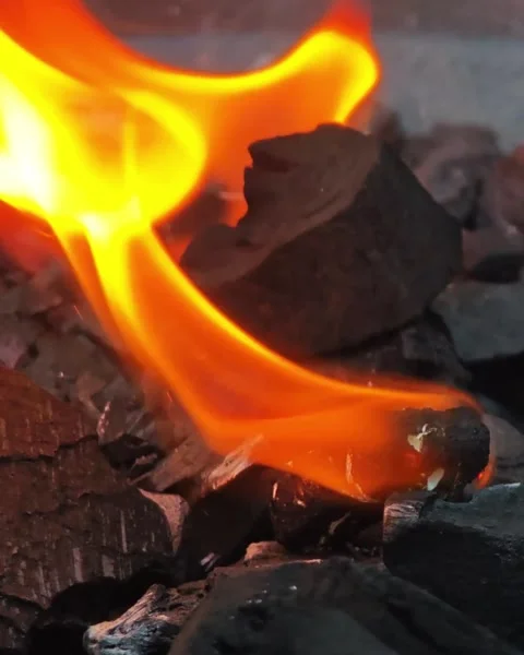 Intense Orange Flame Dancing Over Glowing Charcoal and Fiery Embers Vídeo Stock 347979779