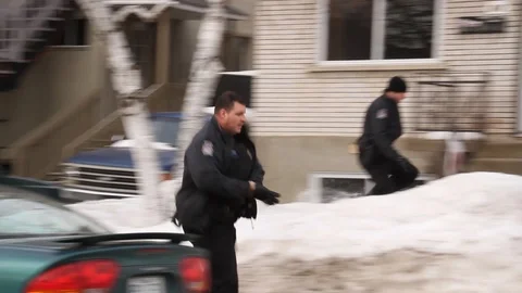Intense police scene with sirens and cops running towards house Stock Footage