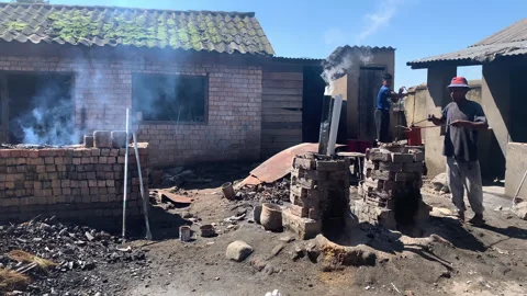 An intense scene showing workers engaged in a traditional smelting process Stock Footage 315690122