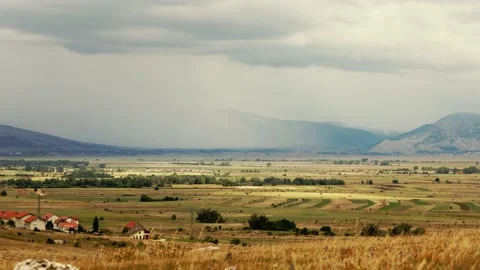 Intense Storm Approaching Valley with Dark Clouds and Rain 動画素材 220782445