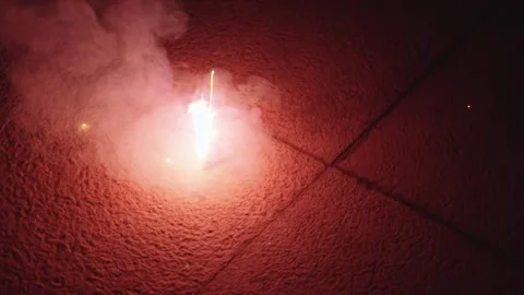 Intense White Sparks Exploding on Rough Stone Pavement at Night Stock Footage 337408588