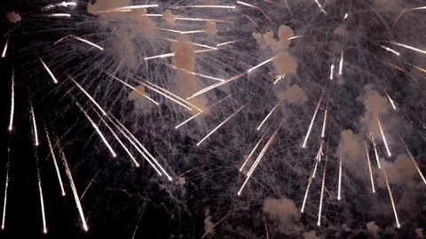 Intense white streaks explode in smoke, closeup finale shot with dense trails Stock Photos