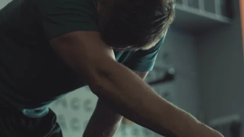 Intense workout session at the gym with man sweating and catching breath Stock Footage 312714301
