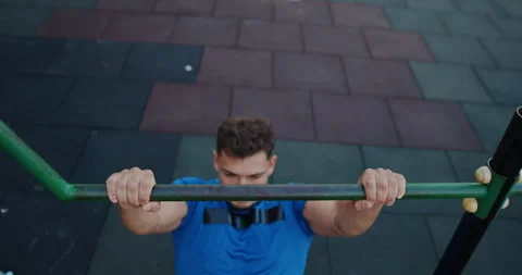 Intense Workout A Young Man Engaged in Performing PullUps at an Outdoor Gym Video stock 317980538