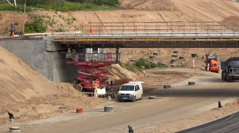 Intensive highway construction works. Skilled people using equipment. zoom in Stock Footage 68757367