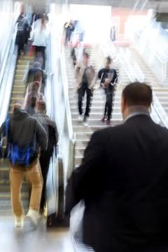 Intentional blurred motion of commuters using London Liverpool Street Escalat Stock Photos