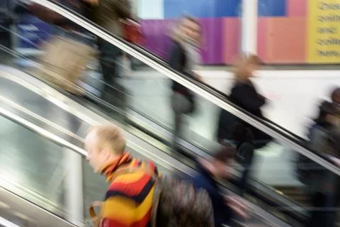 Intentional blurred motion of commuters using London Liverpool Street Escalat Stock Photos
