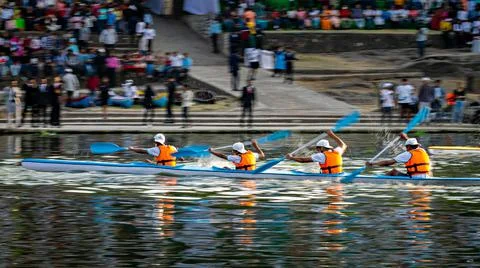 Intentional camera movement, pan image of speeding kayak with four young part Stock Photos