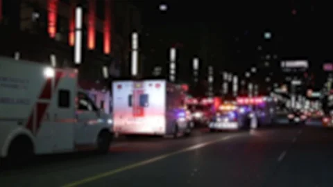 A intentionally blurred out background of emergency vehicles on a busy city Stock Footage 118169456