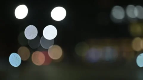 Intentionally blurred traffic lights and cars in the city at night. Видео 301887975