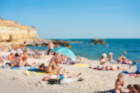Intentionally out of focus image of people relaxing and having fun at a beach Stock Photos