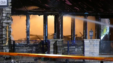 Intentionally set fire at bar becomes total inferno destroying everything Video stock 129987835
