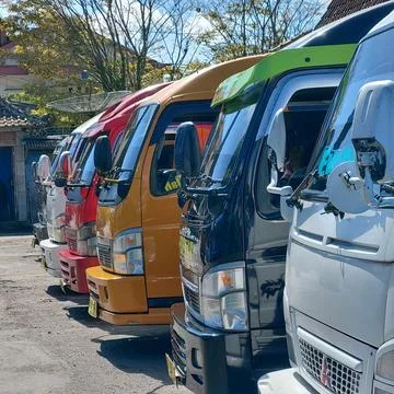 Inter-city mini bus parked neatly at the terminal Stock Photos