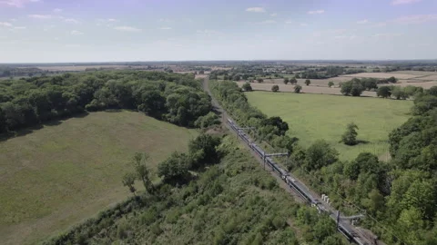 An Inter City train passing through the Wiltshire countryside, England UK. Stock Footage 315446733