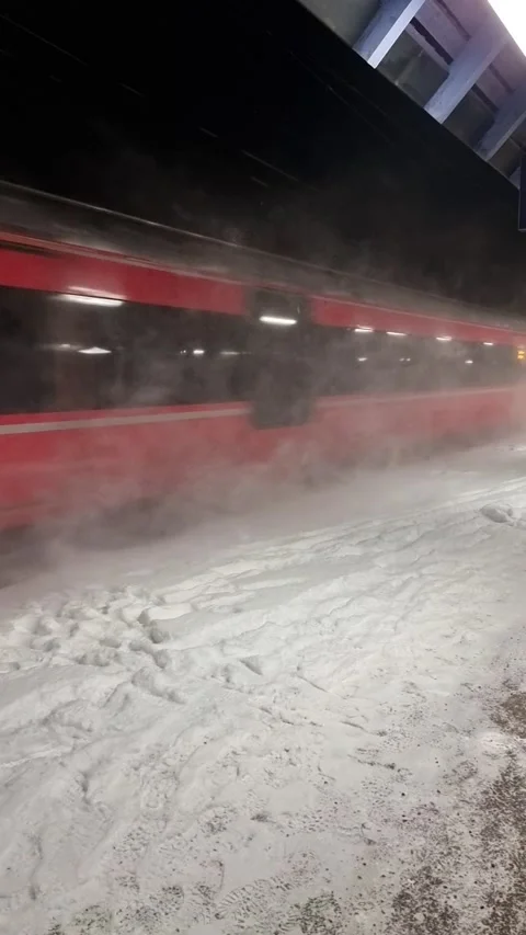 Inter city train, passing a train station, high speed, in snow at winter, Norway Stock Footage 224437134