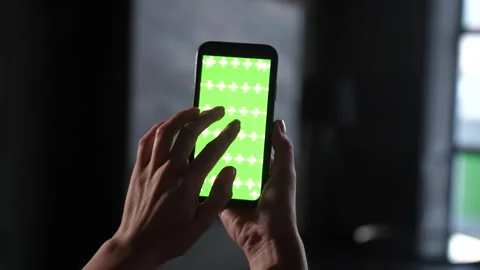 Interacting with mobile phone green screen for advertising space on surface. Stock Footage 166542558