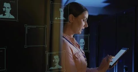 Interacting technician tapping tablet in data center, with holographic panels Stock Photos