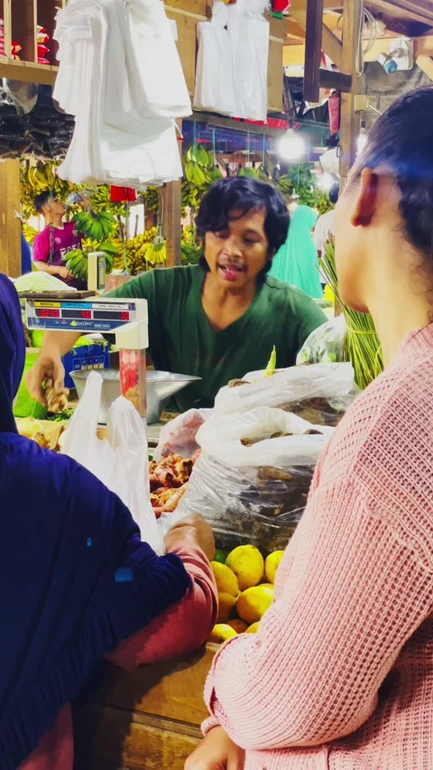 Interaction atmosphere between a seller and a buyer at a traditional market Stock Footage 328615520