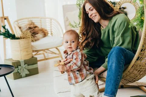 Interaction between an active toddler and a young mother at home. Spending time Stock Photos