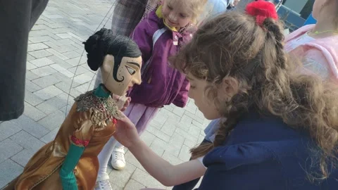 Interaction of the doll with children Stock Footage 155684979