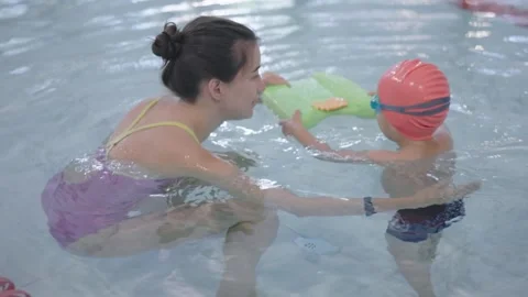 An Interactive and Engaging Swimming Lesson Focused on the Child and Instructor Stock Footage 307240174