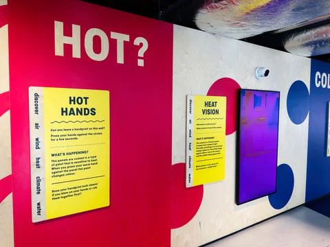 Interactive heat vision and Hot Hands exhibit wall with bright signage and .. Stock Photos