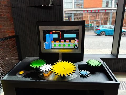 Interactive mechanical gear exhibit with colorful cogs and animated conveyo.. Stock Photos