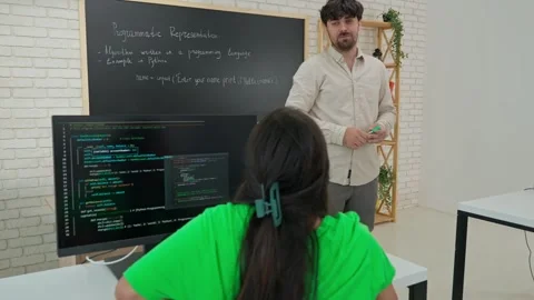 Interactive Programming Lesson with Attentive Student and Instructor Stock Footage 281071572