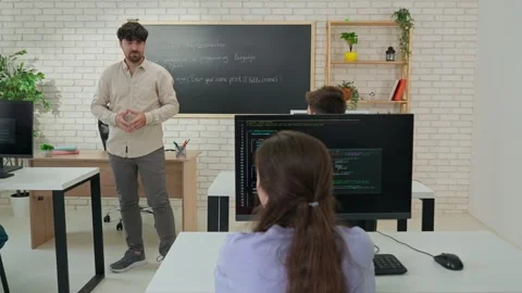 Interactive Programming Lesson with Attentive Student and Instructor Stock Footage 281071685