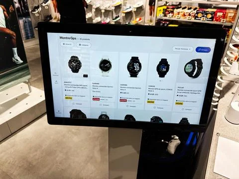Interactive retail kiosk displaying smartwatch product listings in a Paris,.. Foto stock